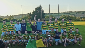 A gaa team called Ballyclough wearing green and yellow jerseys celebrating winning the county jbhc title